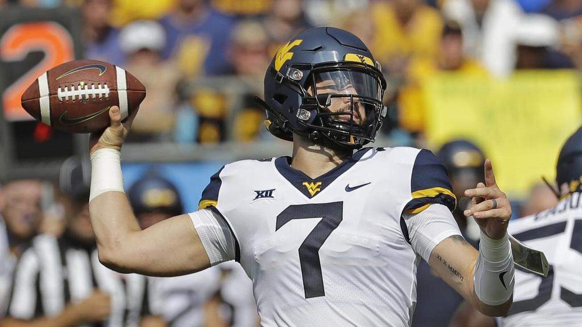 West Virginia’s Will Grier looks to pass against Tennessee in the first half of Saturday’s college football game at Bank of America Stadium.