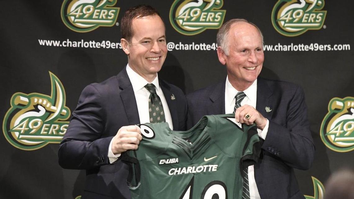 Charlotte 49ers incoming athletics director Mike Hill (left) and Chancellor Philip Dubois pose for pictures Tuesday afternoon during the introductory news conference at the Barnhardt Student Activity Center. Hill, who will officially start his new job on March 15, will succeed Judy Rose, who is retiring.