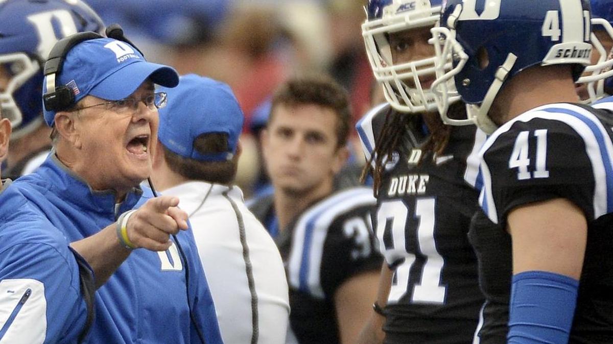 Duke coach David Cutcliffe, left, talks to punter Will Monday on Oct. 3 at Boston College. Virginia Tech head coach Frank Beamer says he’s impressed with the job Cutcliffe has done at Duke. The No. 23 Blue Devils face the Hokies in Blacksburg on Saturday.