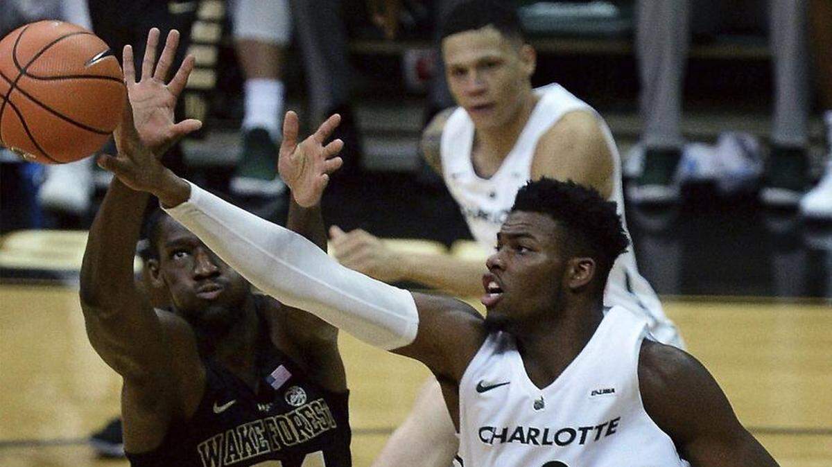 Wake Forest forward Sunday Okeke, left and Charlotte center Jailan Haslem, right, battle for control of a rebound during the first half of an NCAA college basketball game in Charlotte on Tuesday