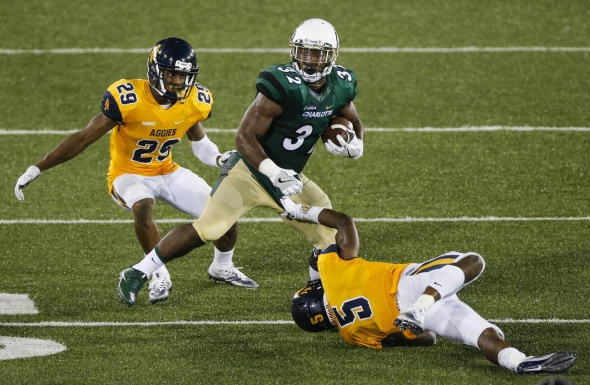 Charlotte 49ers running back Benny LeMay (32) spins to escape the North Carolina A&T defense during Saturday’s game at Jerry Richardson Stadium.