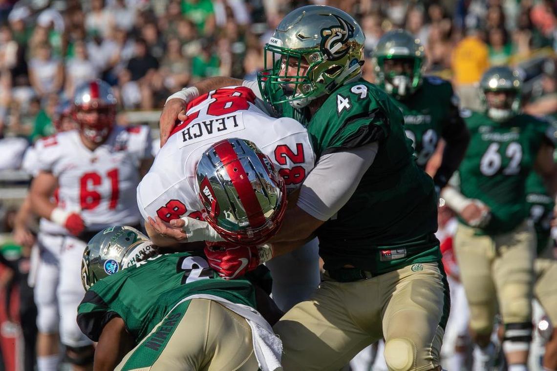 Charlotte 49ers linebacker Jeff Gemmell tackles Western Kentucky tight end Kris Leak in Saturday’s Conference USA football game at Richardson Stadium.