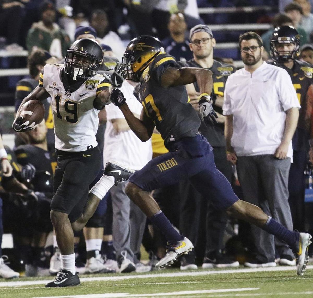Appalachian State running back Daetrich Harrington (19) tries to run past Toledo defensive back Kahlil Robinson (27) during the first half of the Dollar General Bowl, Saturday, Dec. 23, 2017, in Mobile, Ala.