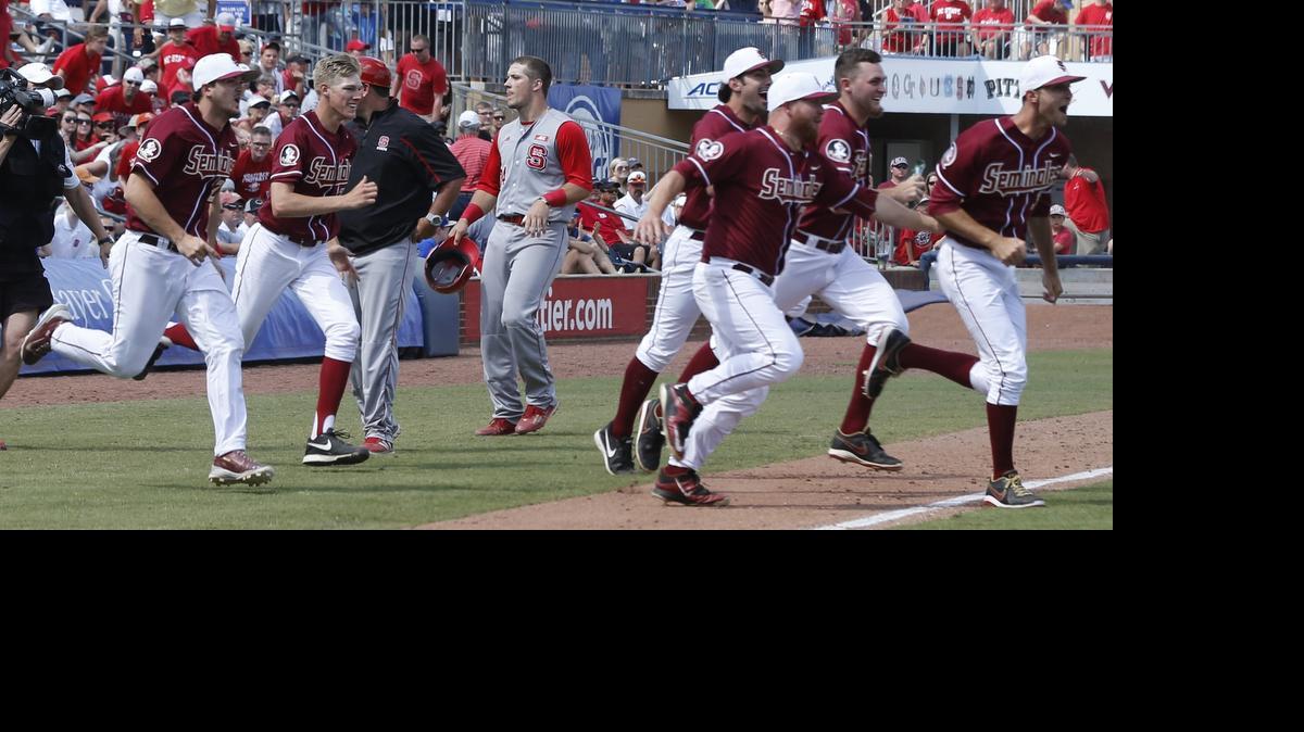 
N.C. State's Chance Shepard (24) heads back to the dugout as Florida State players rush the field after Florida State's 6-2 victory over N.C. State in the ACC Baseball Championship at the Durham Bulls Athletic Park in Durham, Sunday, May 24, 2015.
