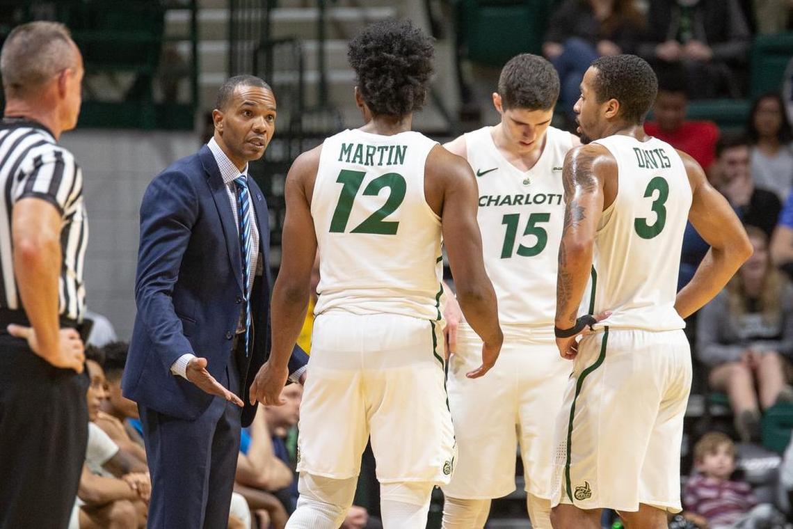 Charlotte 49ers coach Ron Sanchez talks strategy with players Malik Martin (12), Milos Supica (15) and Jon Davis (3) during Saturday’s Conference USA men’s basketball game at Halton Arena. North Texas won 73-66.