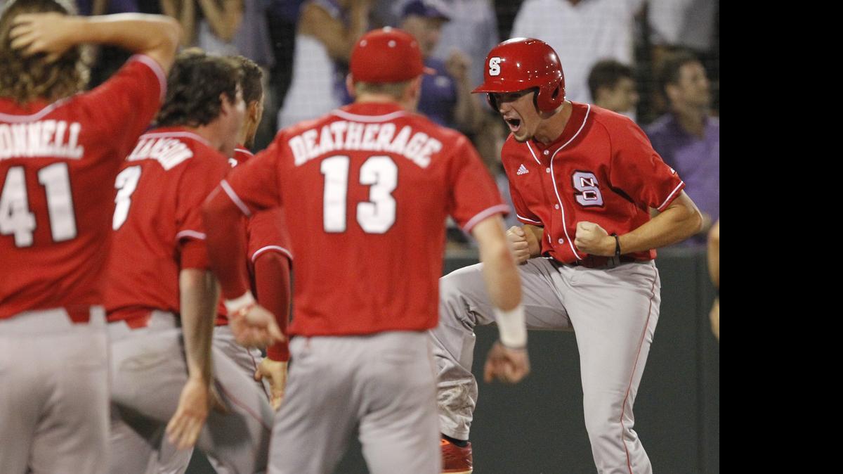 
N.C. State's Tommy DeJuneas, right, is greeted at home plate by teammates after scoring the tying run against TCU on a two-run home run hit by designated hitter Chance Shepard in the ninth inning at the Fort Worth Regional of the NCAA college baseball tournament.

