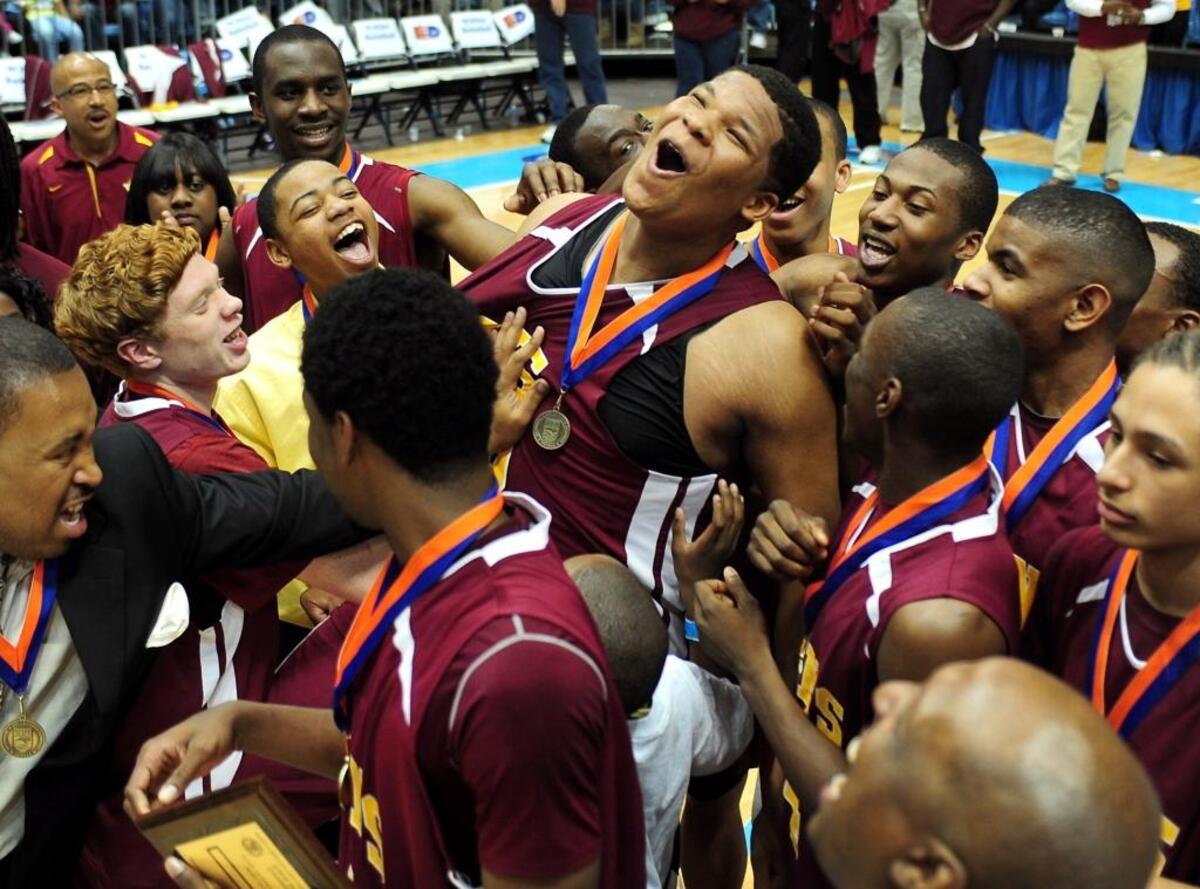 West Charlotte’s Kennedy Meeks, center, is congratulated by teammates after he was named MVP in the N.C. 4A Championship game in March 2011. West Charlotte defeated Raleigh Millbrook 78-69 in the Smith Center on the campus of the University of North Carolina.