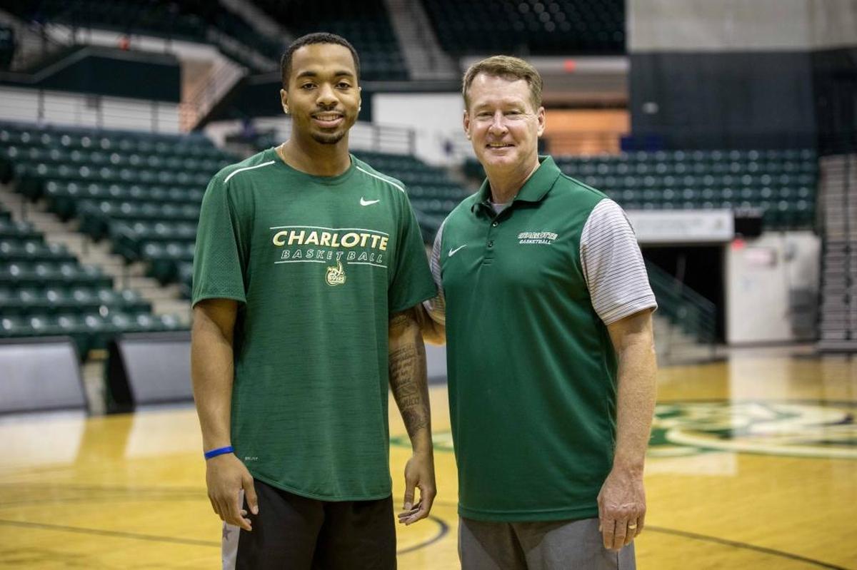 Charlotte 49ers guard Jon Davis, left, and former coach Mark Price pose for a picture during the preseason. After starting the season with a 3-6 record, Price was fired.