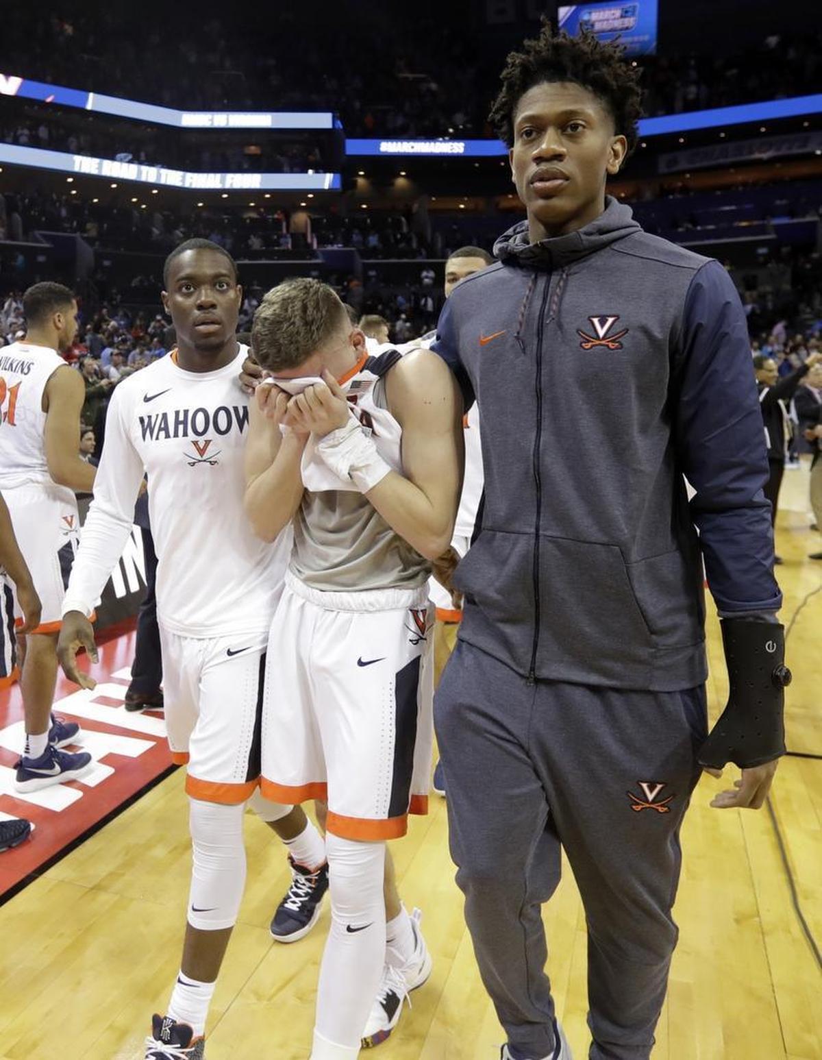 Virginia's Kyle Guy, center, walks off the court following the team's 74-54 loss to UMBC in a first-round game in the NCAA men's college basketball tournament. “There's not really a whole lot that can prepare you for this kind of feeling,” Guy said.