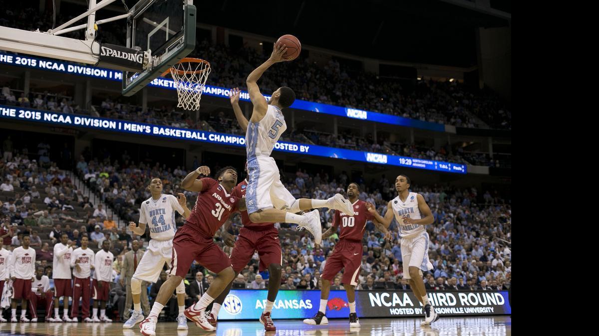 
North Carolina’s Marcus Paige (5) drives to the basket against Arkansas’ Anton Beard (31) during  an NCAA Tournament game on March 21, 2015 at the Jacksonville Veterans Memorial Arena in Jacksonville, Fla.
