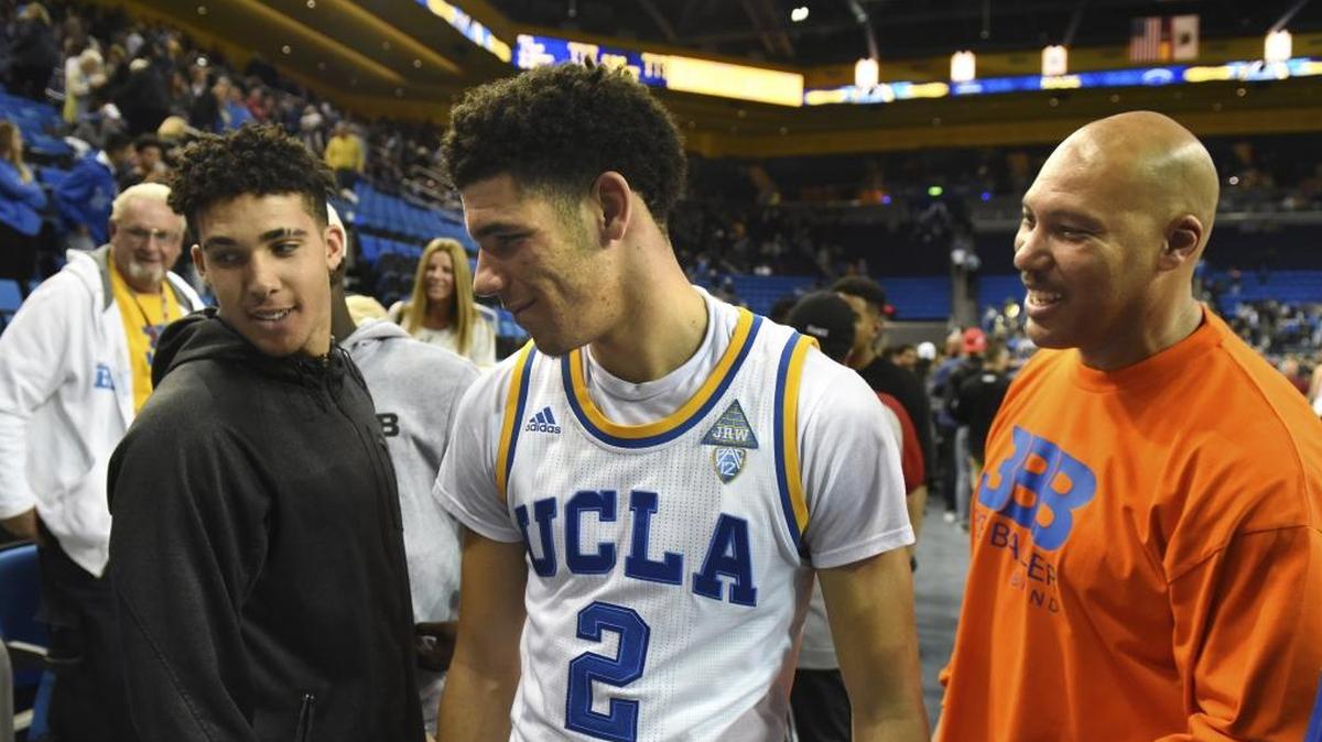 FILE - In this Nov. 20, 2016, file photo, UCLA's Lonzo Ball (2) greets his brother LiAngelo Ball, left, and father LaVar Ball, right, after scoring 20 points in their 114-77 win over Long Beach State at an NCAA college basketball game in Los Angeles. The UCLA Bruins open preparations for a new season with another Ball brother in the lineup. With Lonzo Ball off to the Lakers after one season, his middle brother LiAngelo takes up residence in Westwood. (AP Photo/Michael Owen Baker, File)