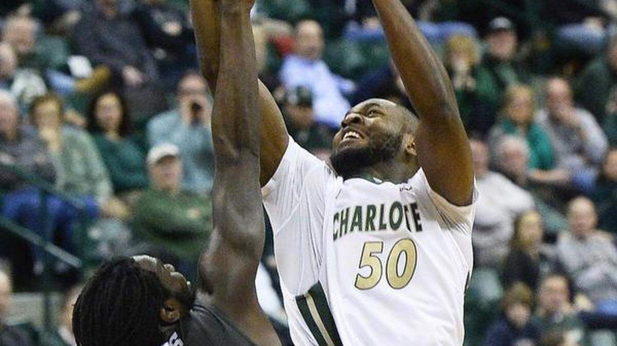 Charlotte 49ers center Joseph Uchebo, right, shoots the ball over Middle Tennessee's Darnell Harrisduring Thursday night's game at UNC Charlotte's Halton Arena. Middle Tennessee defeated the Charlotte 49ers, 73-72.