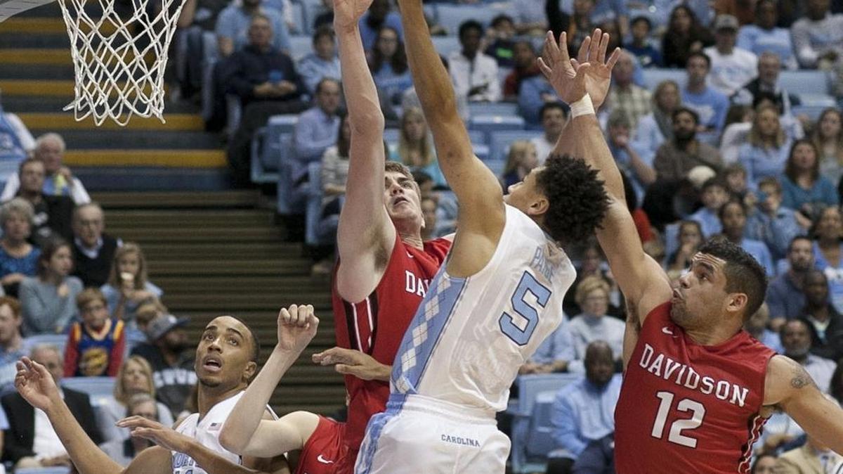 North Carolina’s Marcus Paige drives to the basket against Davidson’s Jack Gibbs (12) and Peyton Aldridge (23) in the second half on Sunday.