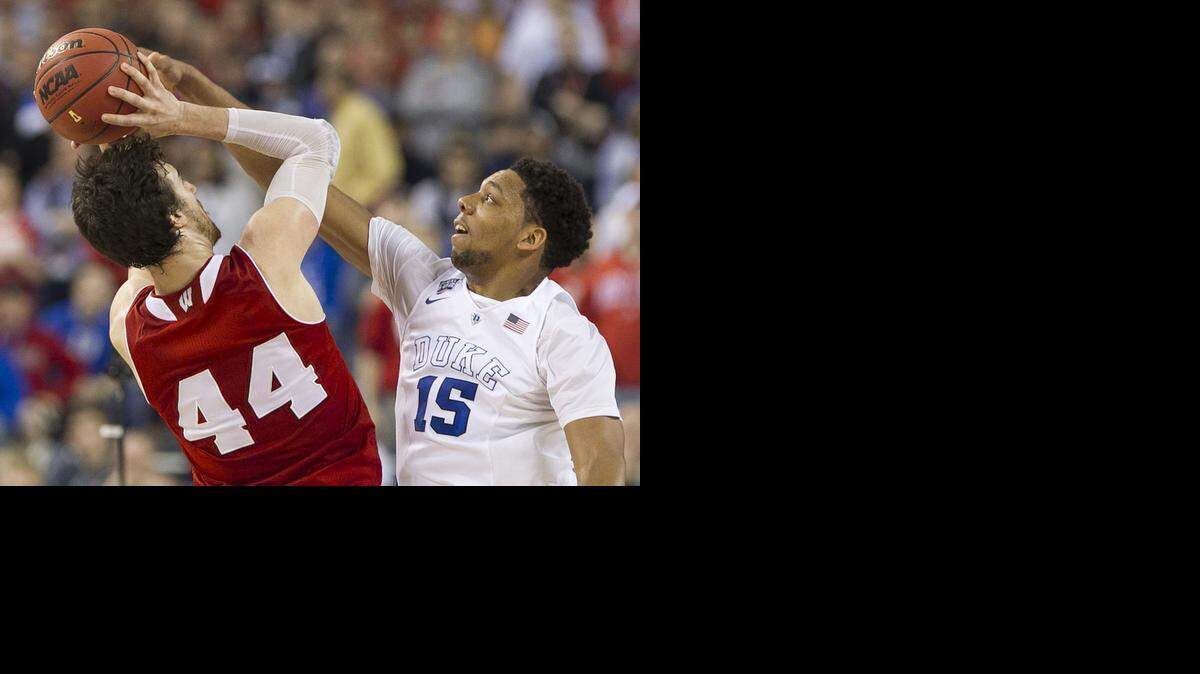 
Duke’s Jahlil Okafor (15) blocks a shot by Wisconsins Frank Kaminsky (44) during the first half in the NCAA championship game on Monday April 6, 2015 in Indianapolis, Indiana. Okafor has decided to enter the NBA draft.
