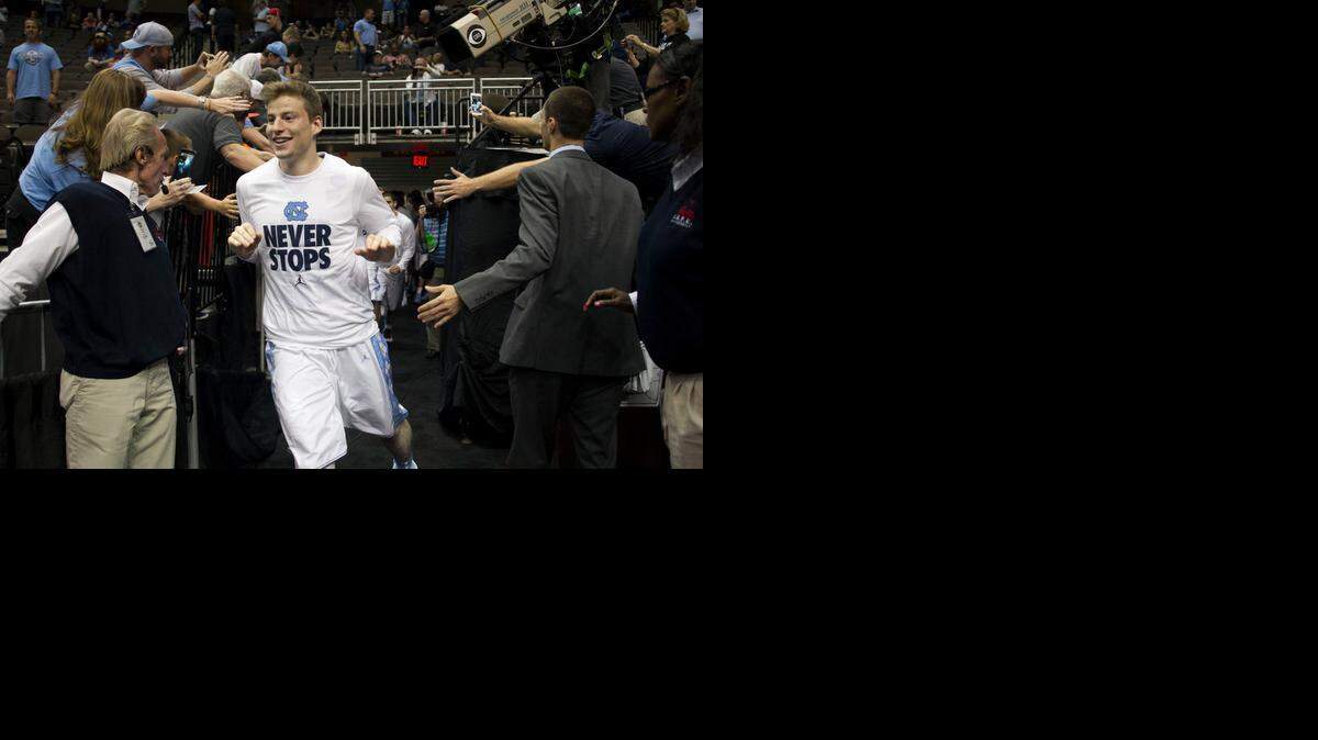 
North Carolina’s Stilman White enters the court Thursday for the Tar Heels NCAA tournament second-round game against Harvard in Jacksonville, Fla. 
