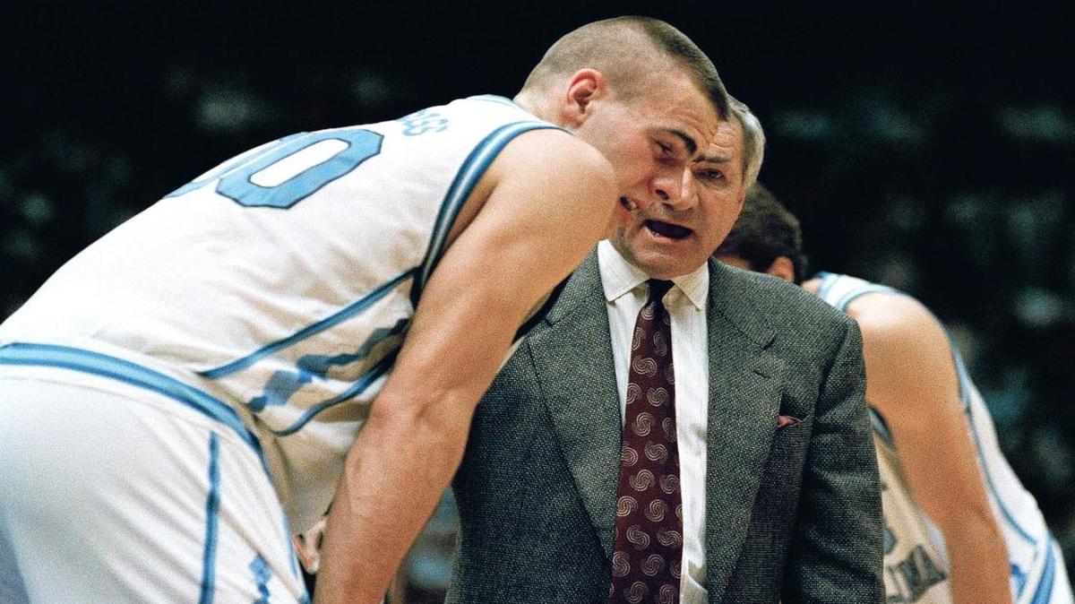 
North Carolina coach Dean Smith has a word with Eric Montross after Montross was poked in the eye during the NCAA East Regional Championship game against Cincinnati on March 28, 1993. The Tarheels advanced to the Final Four with their 75-68 win. 
