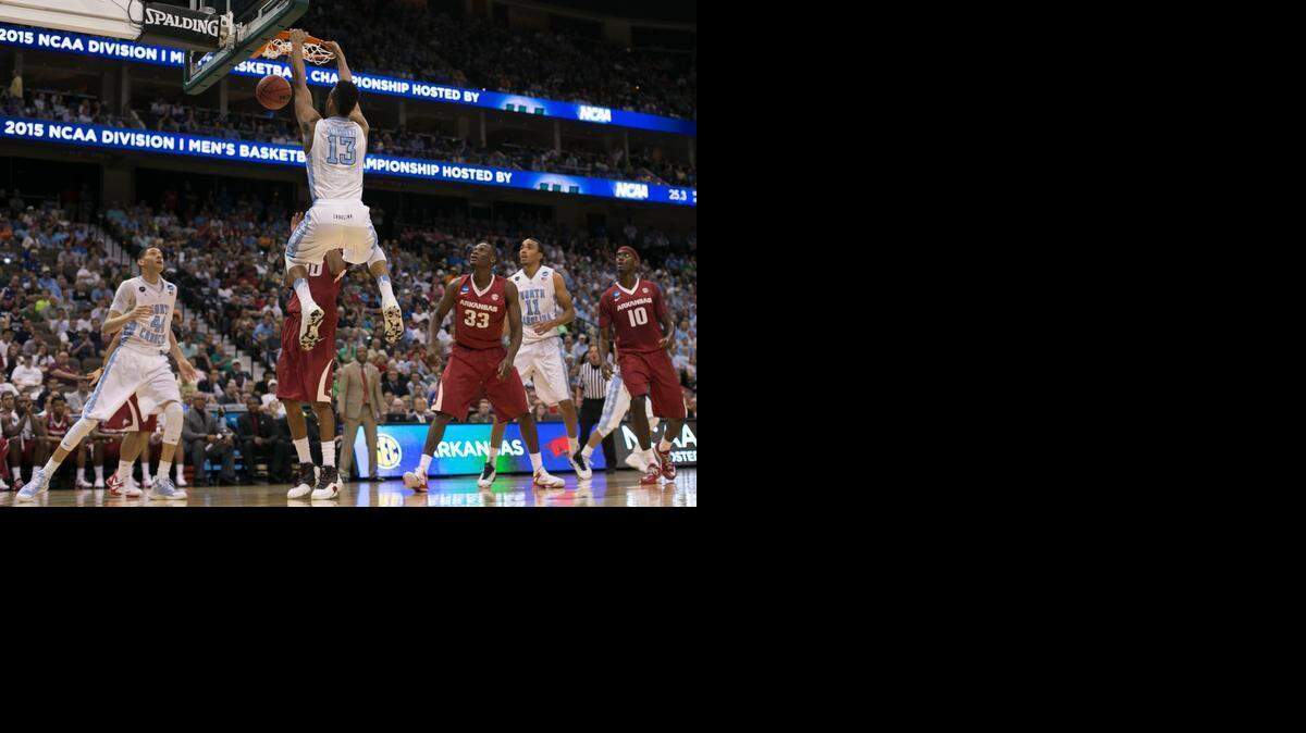 
North Carolina’s J.P. Tokoto (13) gets a dunk in the first half against Arkansas in the NCAA tournament on Saturday, March 21, 2015 at the Jacksonville Veterans Memorial Arena in Jacksonville, Fla.
