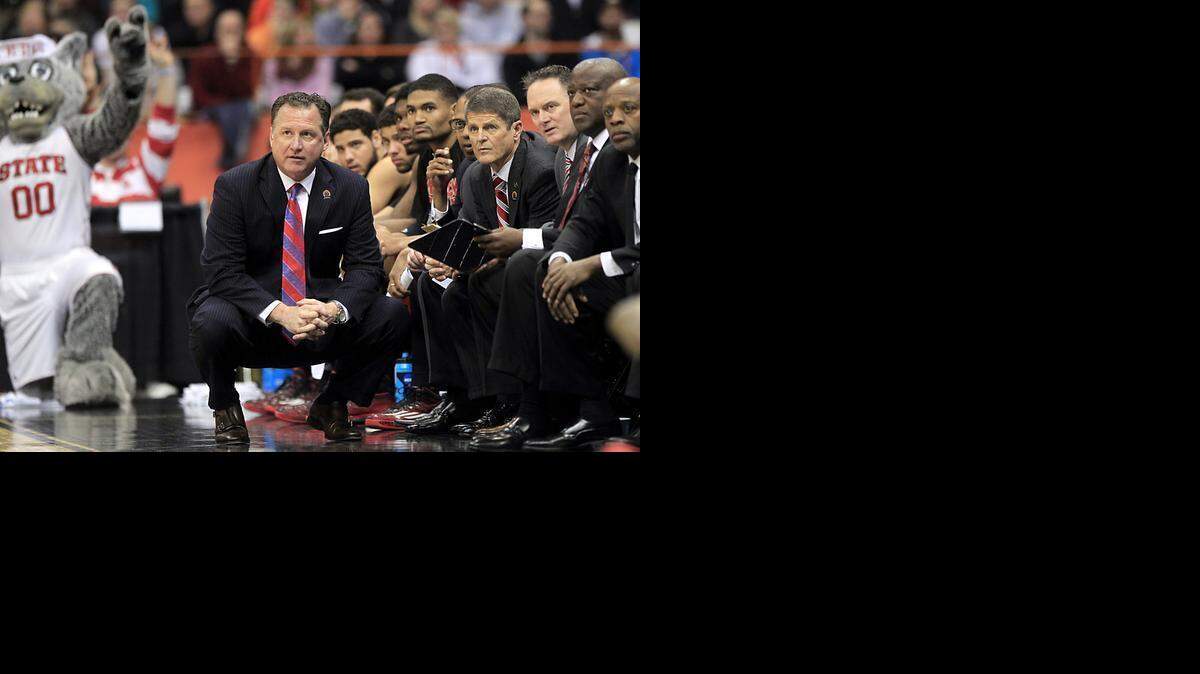 
N.C. State coach Mark Gottfried watches during the first half of the Wolfpack's game against Louisville in the semifinals of the NCAA East Region at the Carrier Dome in Syracuse.
