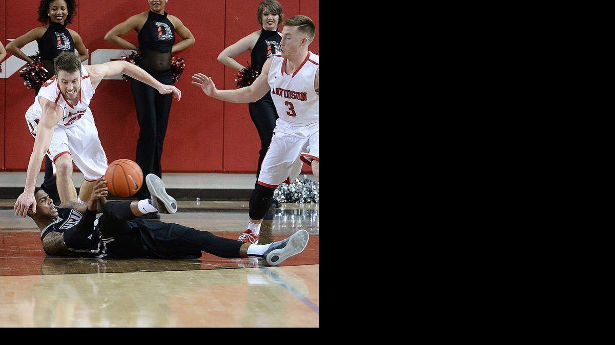 
Davidson's Tyler Kalinoski and VCU 22 Terry Larrier go after a loose ball during the VCU at Davidson Atlantic 10 men's basketball game on March 5, 2015 at Belk Arena. 
