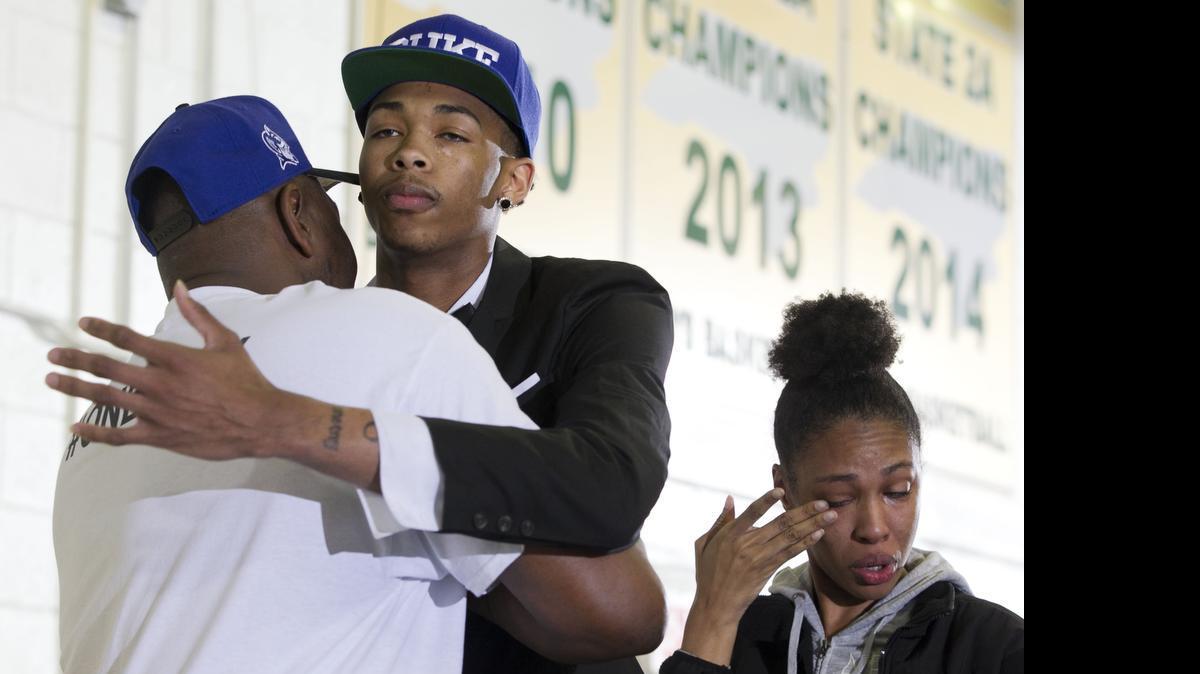 
Highly recruited basketball player Brandon Ingram, a senior at Kinston High School, announces that he will attend Duke University on Monday, April 27, 2015 at Kinston High School in Kinston. Ingram embraces his father Donald Ingram as his sister Brittany Callender wipes away tears following the announcement. 
