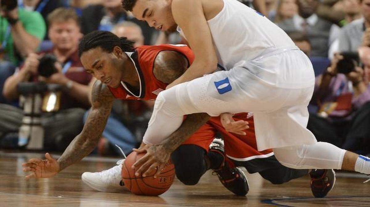 N.C. State’s guard Cat Barber <137>(12) <137>gets the ball stolen by Duke’s <137>guard <137>Tyus Jones <137>(5) <137>in the first half of play at the quarterfinal round of the Atlantic Coast Conference basketball tournament at the Greensboro Coliseum<137> in Greensboro, N.C. Thursday, March 12, 2015<137>.
