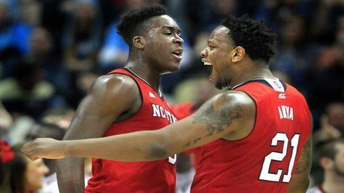 
N.C. State's BeeJay Anya (21), right, celebrates with Abdul-Malik Abu (0) after Anya blocked a shot during the first half of the Wolfpack's game against the Wildcats in the third round NCAA Division I Men's Basketball Tournament at the Consol Energy Center in Pittsburgh.
