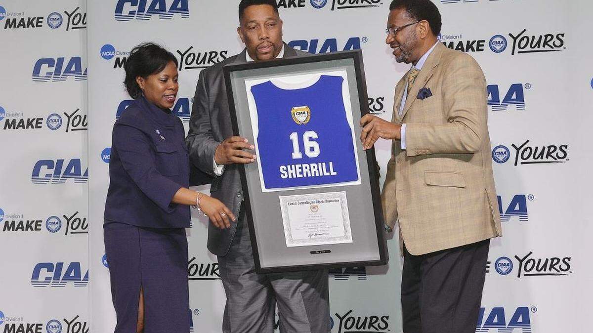 Former Johnson C. Smith basketball standout Mark Sherrill, center, was inducted into the CIAA Hall of Fame Friday morning at the Charlotte Convention Center. CIAA Commissioner Jacqie McWilliams, left, and J.C. Smith President Ron Carter presented Sherrill with his Hall of Fame jersey award.