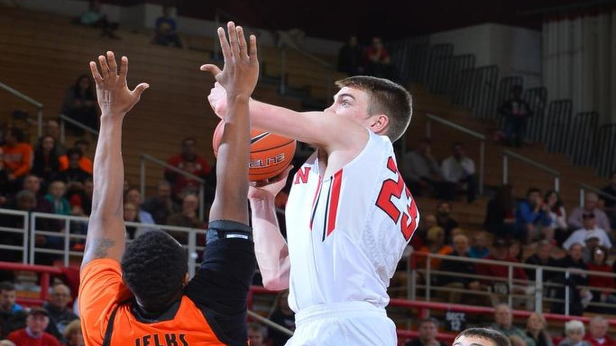 Davidson’s Peyton Aldridge shoots over Mercer’s Stephon Jelks to score two of his game-high 23 points.