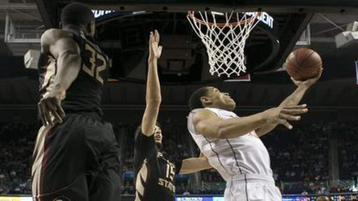 
Virginia’s Malcolm Brogdon  drives to the basket for a reverse layup during the first half against Florida State during the quarterfinals of the ACC  tournament at the Greensboro Coliseum.
