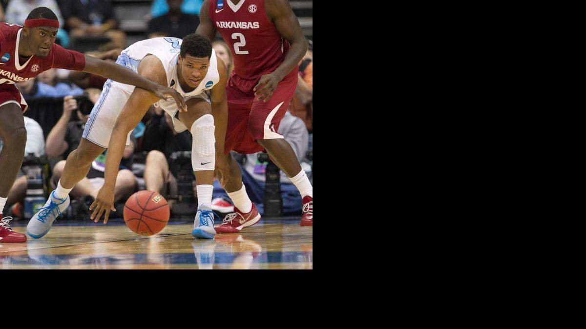 
Arkansas Bobby Portis (10) and North Carolinas Kennedy Meeks (3) eye a loose ball during the second half in the third round of the NCAA Tournament on Saturday, March 21, 2015 at the Jacksonville Veterans Memorial Arena in Jacksonville, Florida. 

