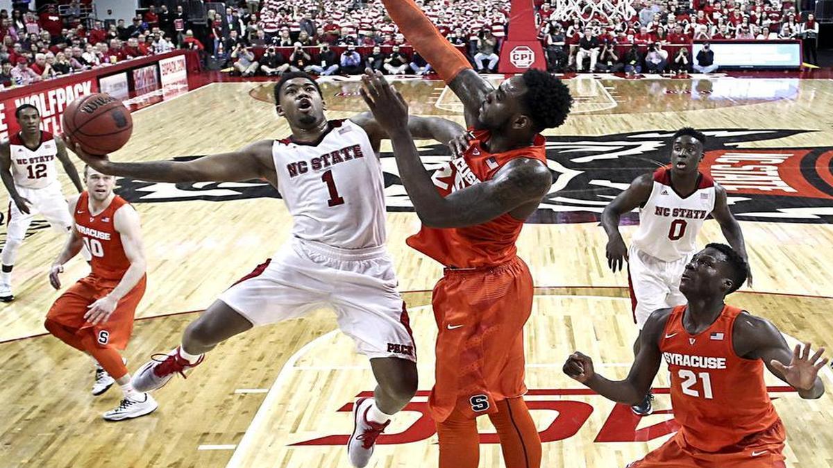 
N.C. State's Trevor Lacey (1) shoots as Syracuse's Rakeem Christmas (25) defends in the second half during N.C. State's 71-57 victory over Syracuse at PNC Arena in Raleigh on Saturday, March 7, 2015.
