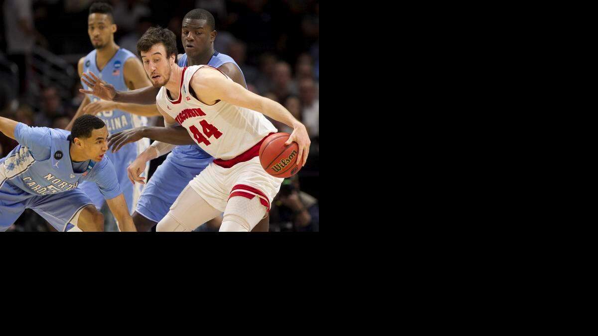 
Wisconsins Frank Kaminsky (44) is trapped by North Carolina’s Marcus Paige (5) and Joel James during the first half of the NCAA West Regionat the Staples Center in Los Angeles.
