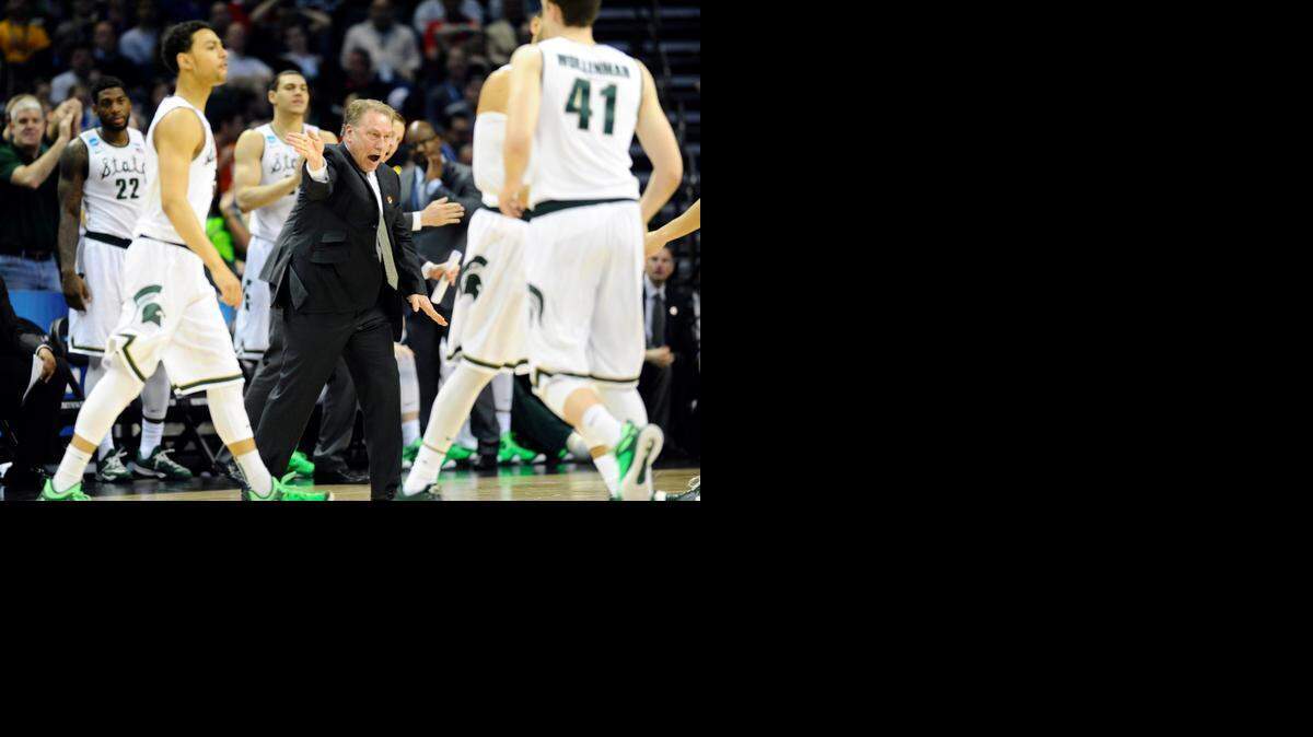 
Michigan State Spartans head coach Tom Izzo talks to his team during a timeout against the Georgia Bulldogs in the first half of their second-round game in the NCAA men's basketball tournament at Time Warner Cable Arena Friday. Michigan State won 70-63. 
