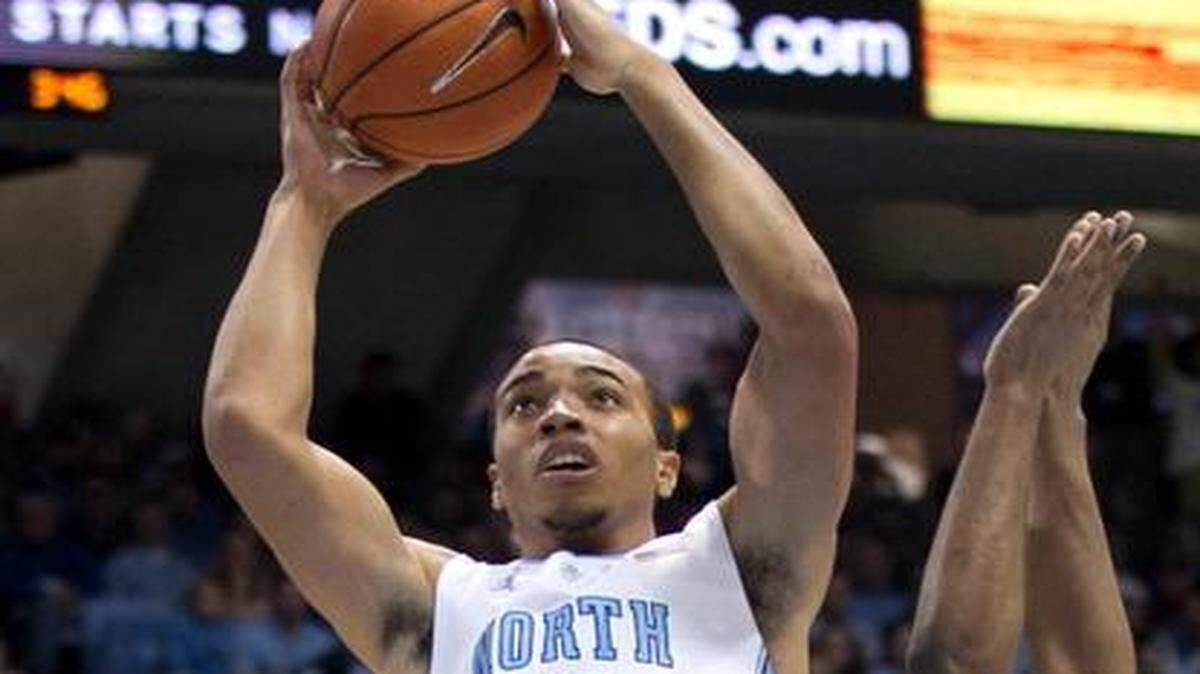 
UNC’s Brice Johnson (11) drives to the basket against Florida State’s Devon Bookert (1) during their game on Saturday, January 24, 2015 at the Smith Center in Chapel Hill. Johnson scored 18 points in UNC’s 78-74 victory. 
