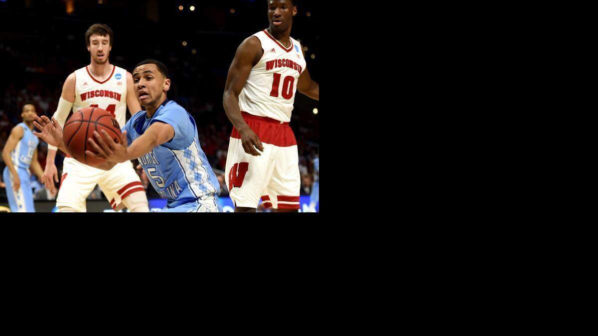 
North Carolina junior guard Marcus Paige grabs the ball in front of Frank Kaminsky during the West Regional Semifinal of the 2015 NCAA Men's Basketball Tournament at Staples Center on Thursday, March 26, 2015 in Los Angeles.


