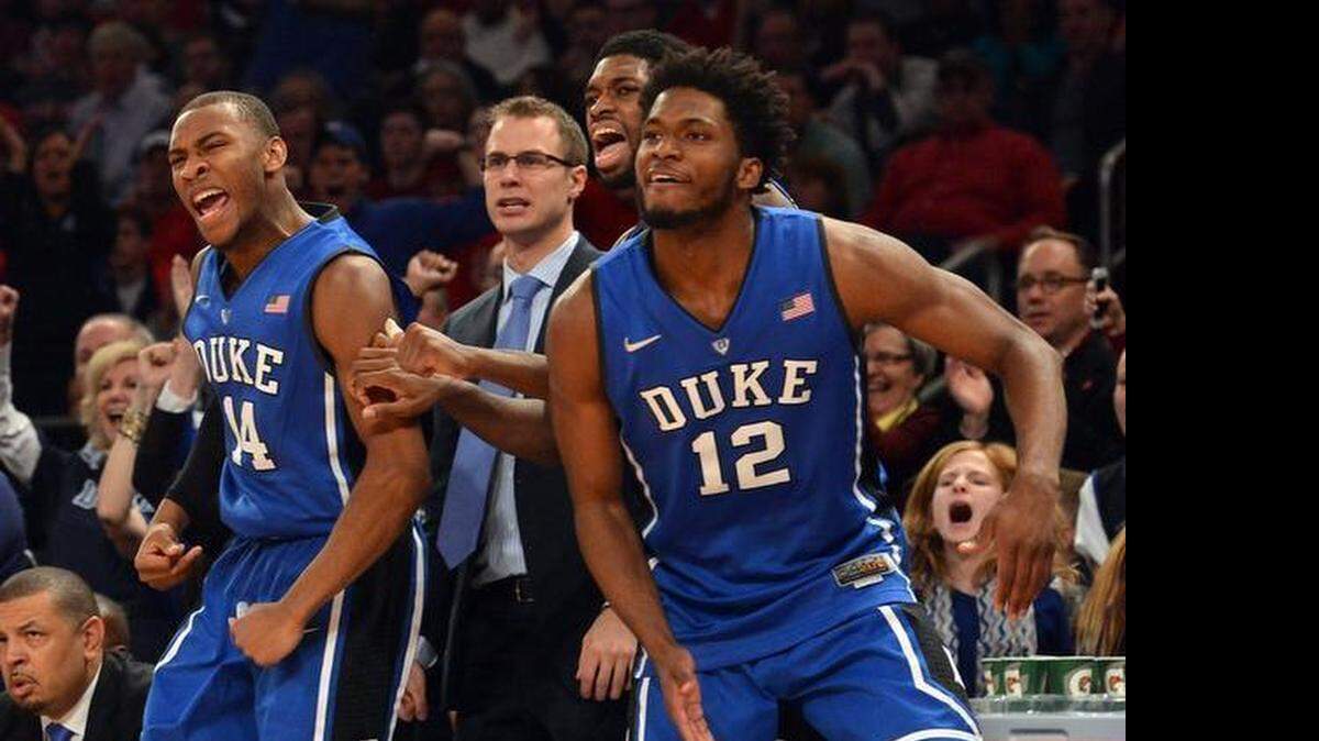 
Duke's Rasheed Sulaimon, left, reacts with assistant coach Jon Scheyer, Amile Jefferson and Justise Winslow during the Blue Devils win at St. John’s on Jan. 25. The victory was Mike Krzyzewski’s 1000th as a coach. Coach K dismissed Sulaimon from the team just four days later.
