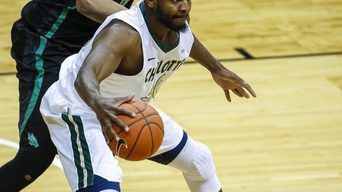 Charlotte center Joseph Uchebo makes his move to the basket against North Texas center Rickey Brice Jr. in the first half of a college basketball game Saturday. Charlotte won 103-79.