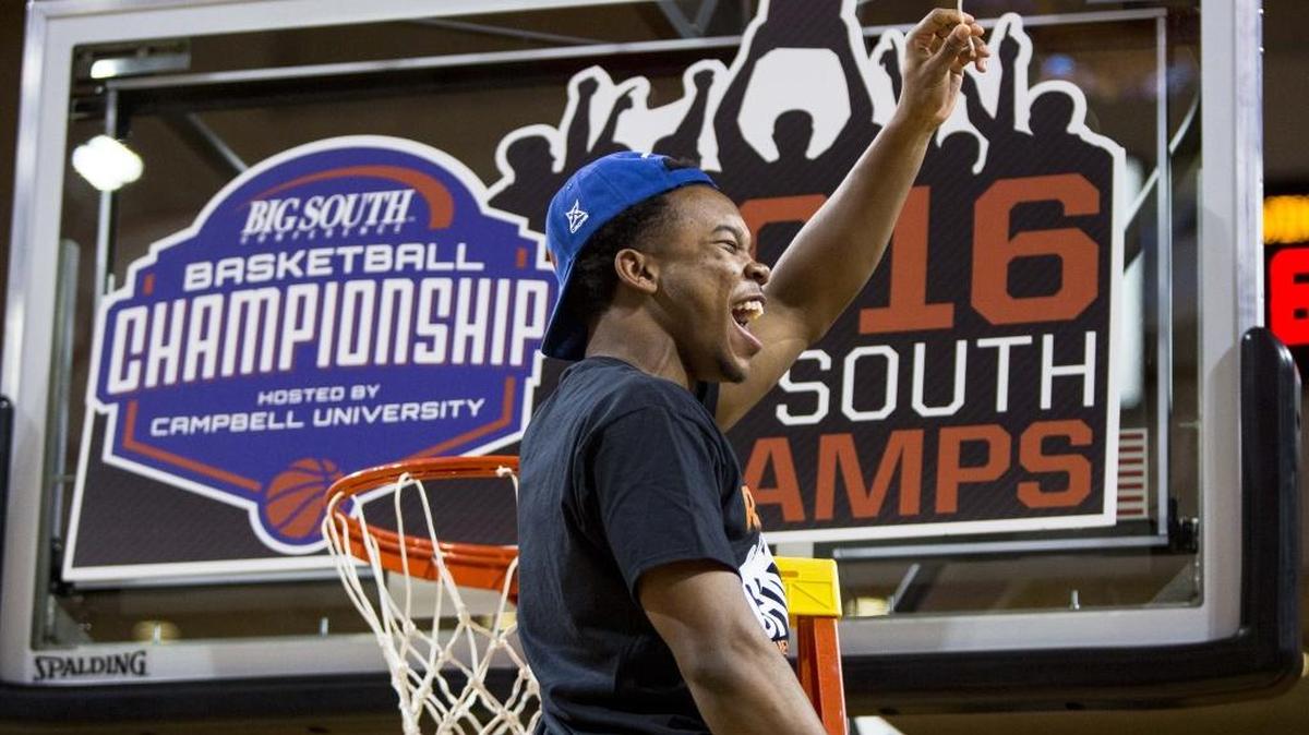 UNC Asheville’s Trae Bryant waves a piece of the net after his team defeated Winthrop, 77-68, in last week’s Big South Conference championship game in Buies Creek.