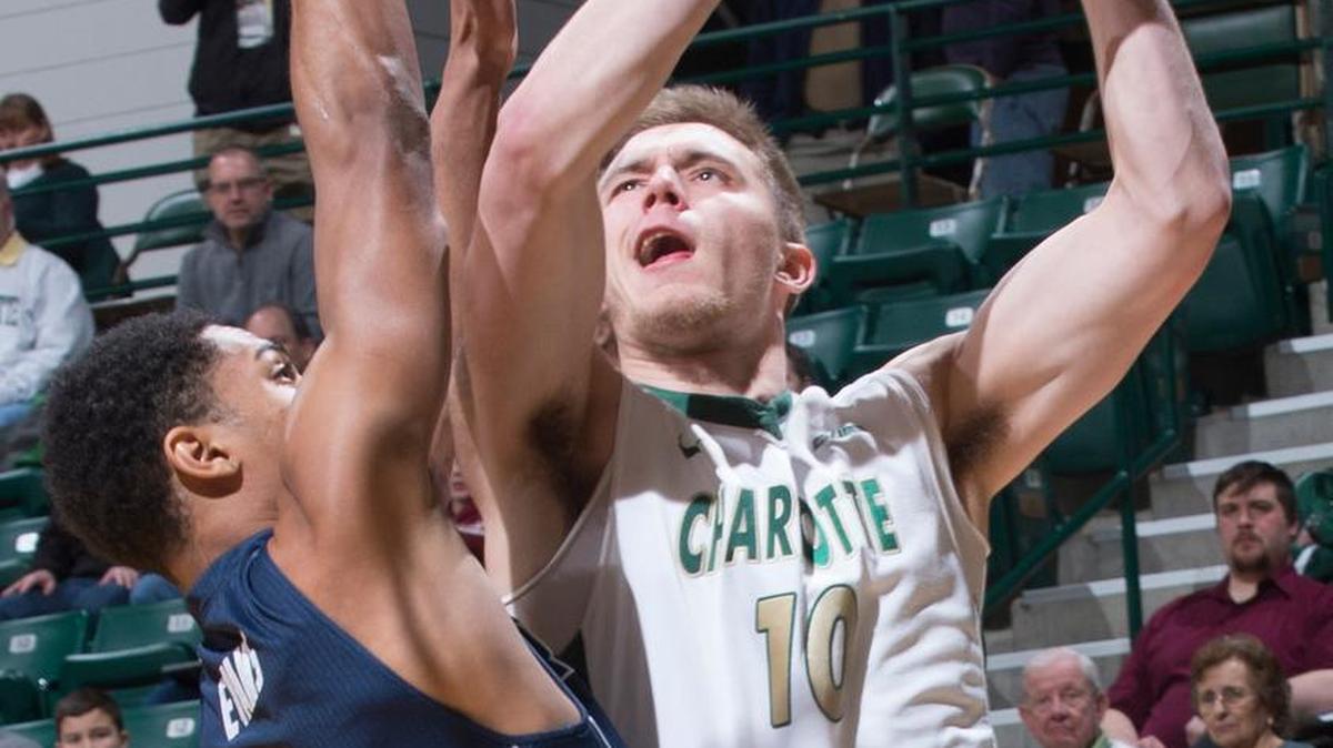 Charlotte’s Curran Scott (10) puts up a shot against the defense of Rice’s Marcus Evans during their game at Halton Arena on Thursday.