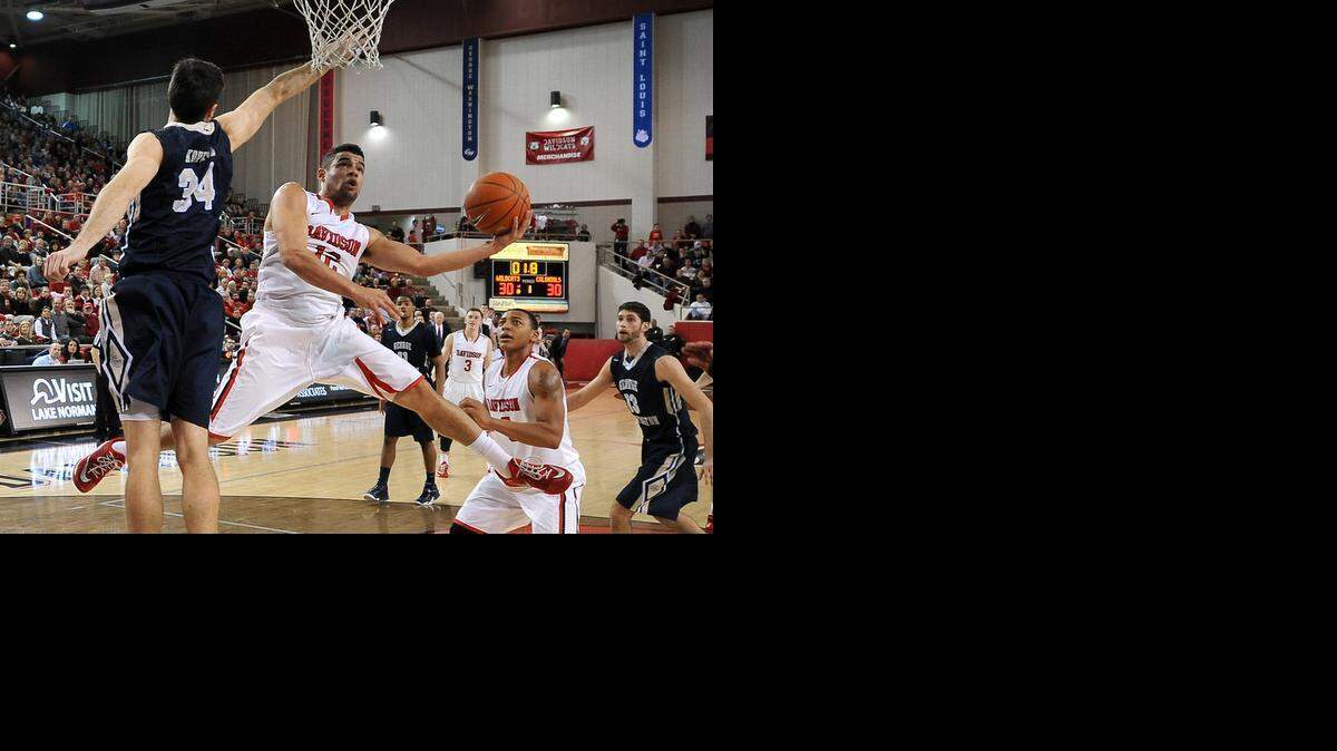 Davidson’s Jack Gibbs slices across the lane for a shot in first half action as George Washington’s John Kopriva applies defensive pressure. Davidson won 77-66.