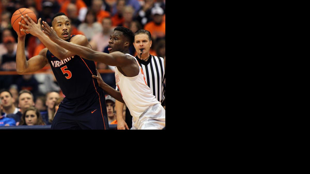 
Virginia’s Darion Atkins, left, looks to pass the ball against Syracuse’s Tyler Roberson on March 2. The Cavaliers have posted back-to-back 16-2 conference records and enter this week’s ACC tournament as the No. 1 seed.
