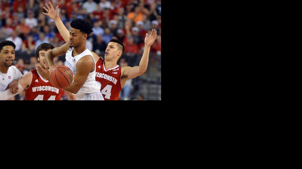 
Duke's Quinn Cook (2) pulls in a rebound from Wisconsin's Bronson Koenig (24) during the first half at Lucas Oil Stadium in Indianapolis.
