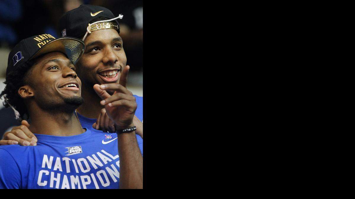 
Duke freshman Justise Winslow, left, and Jahlil Okafor, enjoy the welcome home celebration in Durham in front of thousands. 
