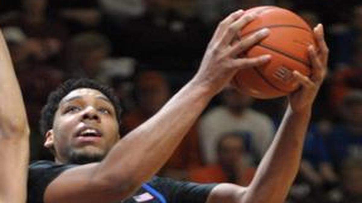 
Duke's Jahill Okafor goes up for a basket against Virginia Tech's Satchel Pierce during the first half Wednesday in Blacksburg, Va. Okafor, whose ankle injury made him a game-time decision, finished with 30 points for the Blue Devils.

