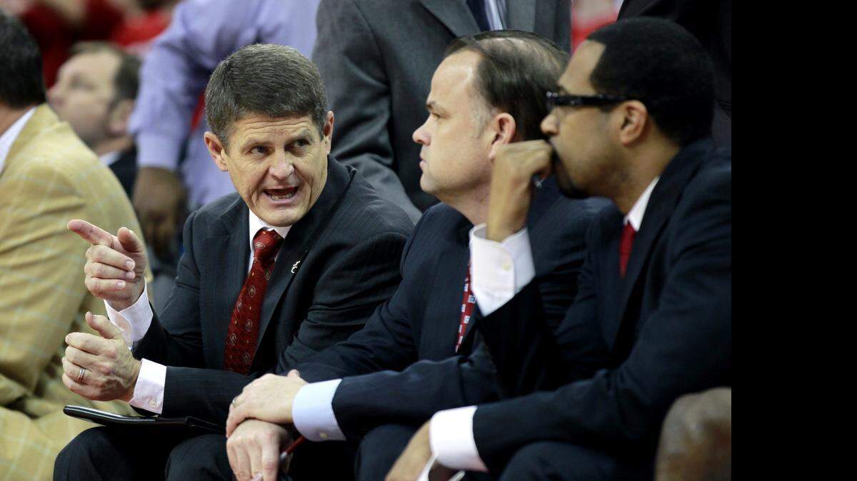 
N.C. State assistant coach Bobby Lutz, left, talks with fellow assistant coaches Rob Moxley, center, and Orlando Early, right, during a 2012 ACC basketball game against Florida State at the RBC Center in Raleigh.

