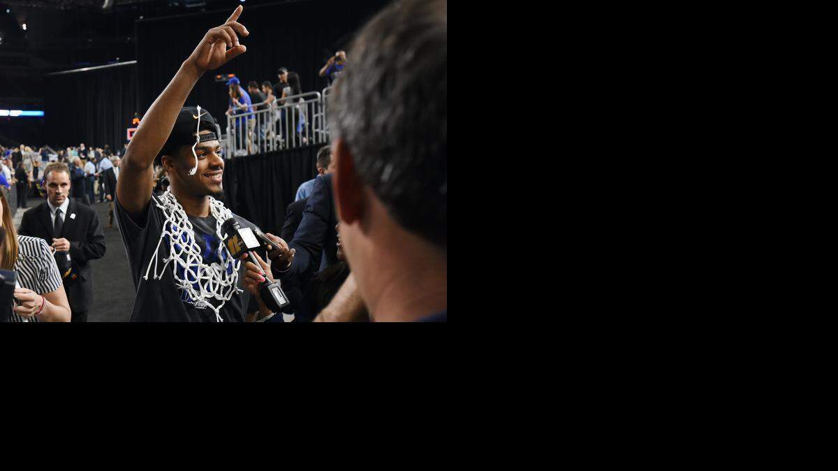 
Duke senior guard Quinn Cook has the game net around his neck  after Duke beat Gonzaga 66-52 for a berth in the NCAA basketball tournament’s Final Four at the NCAA South Region, Sunday, March 29, 2015 at the NRG Stadium in Houston.
