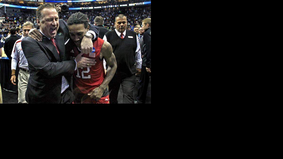 
N.C. State coach Mark Gottfried celebrates with guard Cat Barber after N.C. State’s 71-68 upset victory against No. 1 seed Villanova in the third round of the NCAA tournament.
