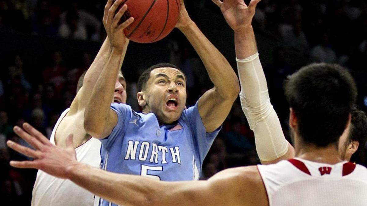 
North Carolina’s Marcus Paige (5) drives to the basket against Wisconsin. For a less taxing game, Paige takes to Twitter and solicits competition from among UNC’s student body. 


