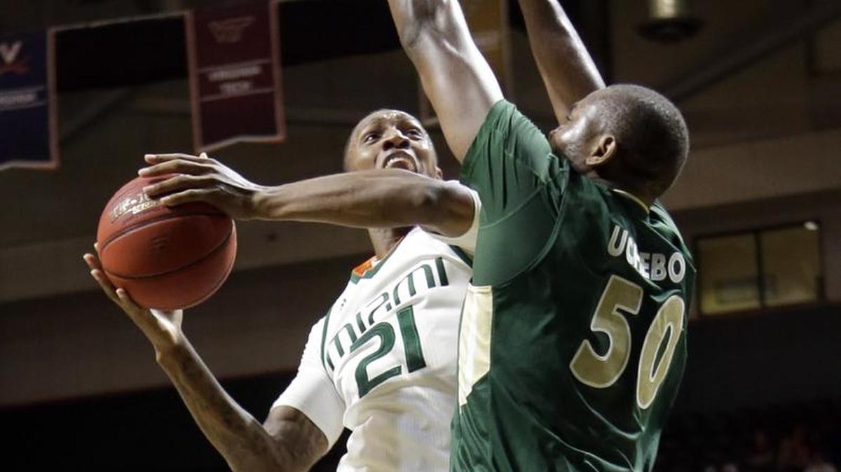 Miami forward Kamari Murphy puts up a shot over Charlotte center Joseph Uchebo Saturday in Miami’s win.