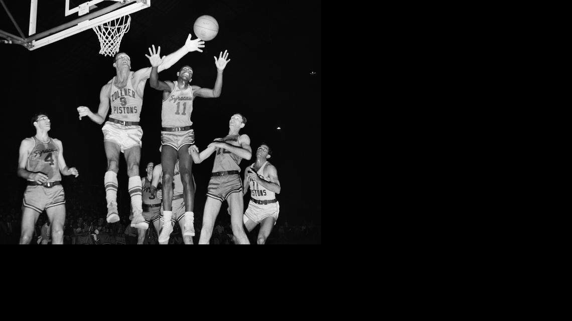 
In this April 1955 file photo, Fort Wayne's Mel Hutchins (9) and Syracuse's Earl Lloyd (11) reach for the ball during an NBA basketball game in Indianapolis. Lloyd, the first black player in NBA history, died Thursday. He was 86. Lloyd's alma mater, West Virginia State, confirmed the death. It did not provide details. Lloyd made his NBA debut in 1950 for the Washington Capitals, just before fellow black players Sweetwater Clifton and Chuck Cooper played their first games. 
